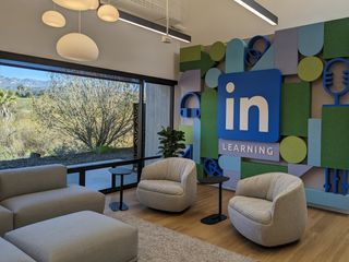 Seating lounge with dimensional felt shapes as colorful wall art and LinkedIn Learning logo.
