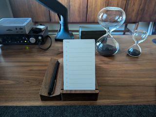 Walnut Analog card stand with matching pen tray and clear hourglasses with black sand on walnut desk.